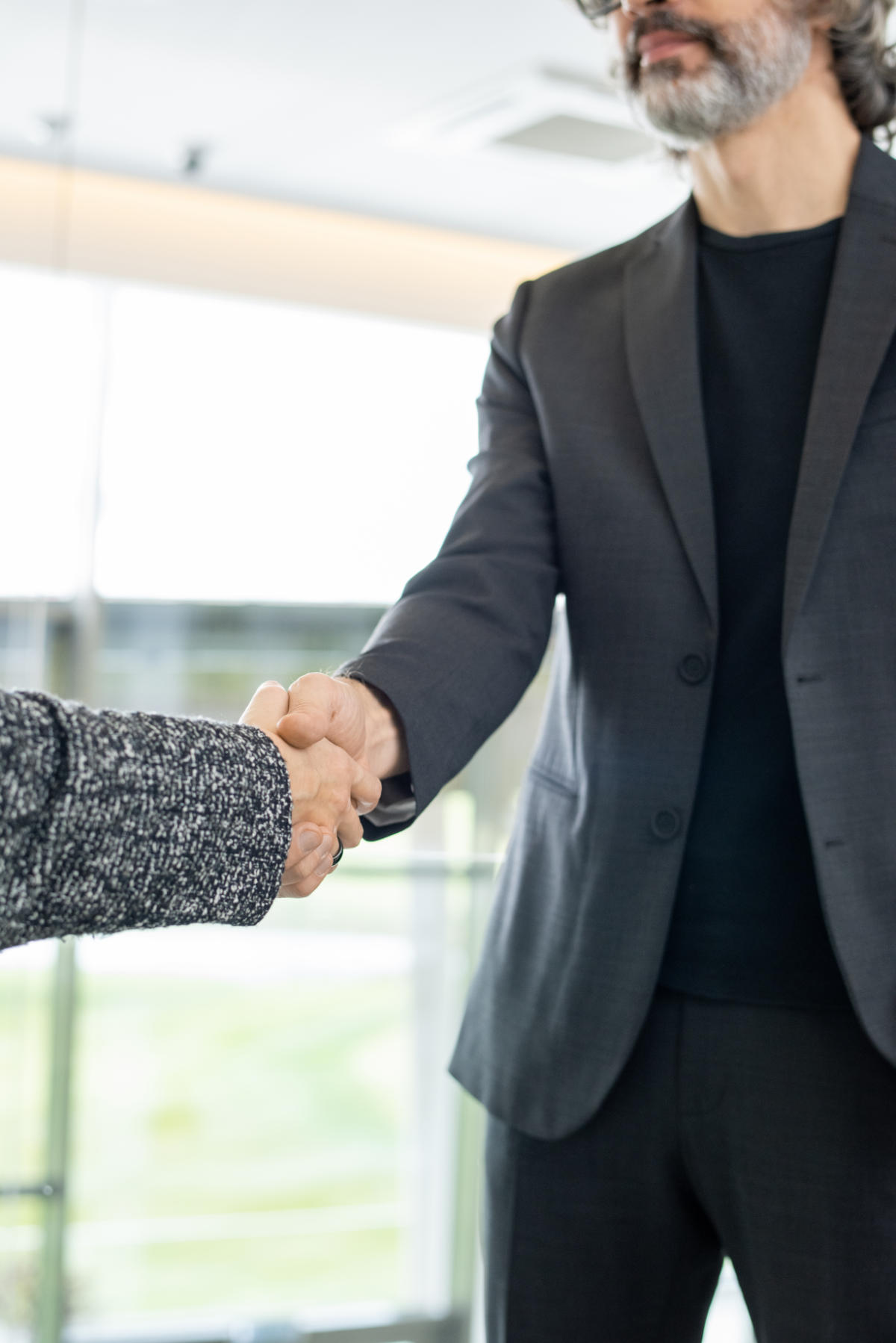 Elegant mature businessman greeting his new colleague or business partner