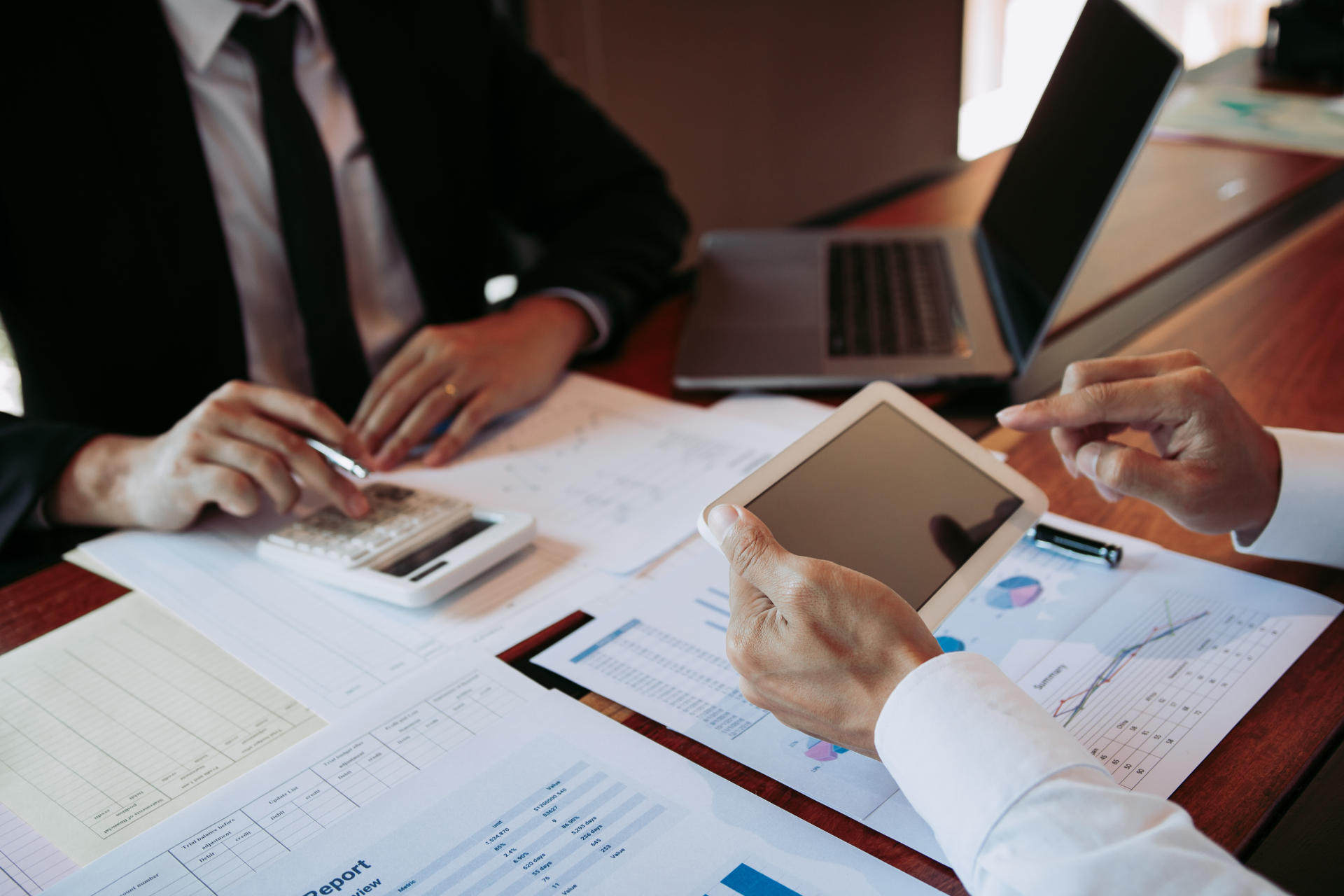 Two businessmen are working analyzing the company annual budget